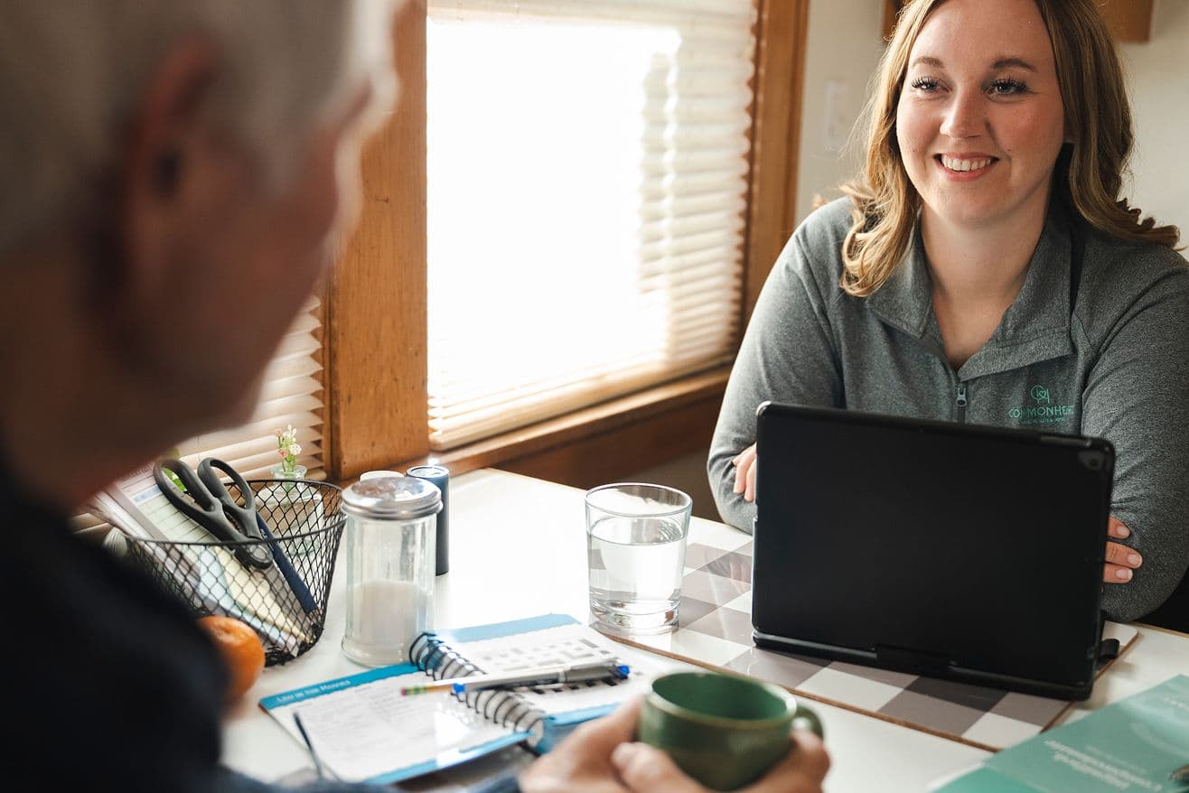 A Commonheart nurse talking with a patient at the table